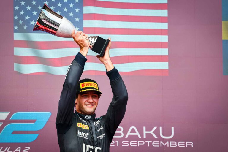 Formula 2 Baku race winner with the trophy on the podium.